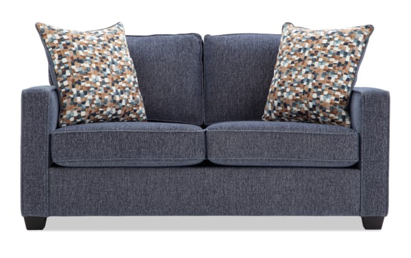 Two-seater navy blue fabric sofa with textured upholstery and two multicolored patterned throw pillows, featuring a modern design with straight armrests.
