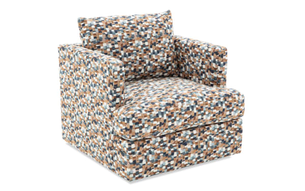 Upholstered armchair with a multicolor pixelated pattern in shades of blue, brown, and white, featuring a cushioned seat and backrest for living room seating.
