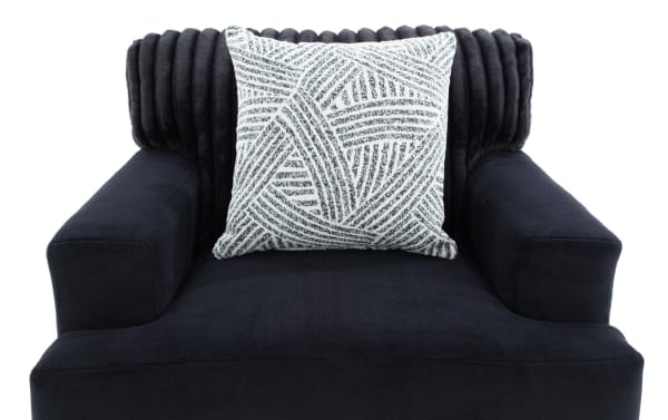 Contemporary Sofia Black Chair with plush polyester fabric upholstery, channel tufted back, and matching black-and-white patterned accent pillow for living room comfort.