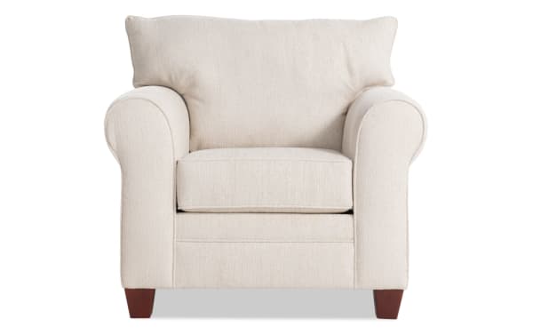 Beige Portland Chair with plush polyester fabric upholstery, memory foam cushion, and transitional style featuring rounded arms and wooden legs.