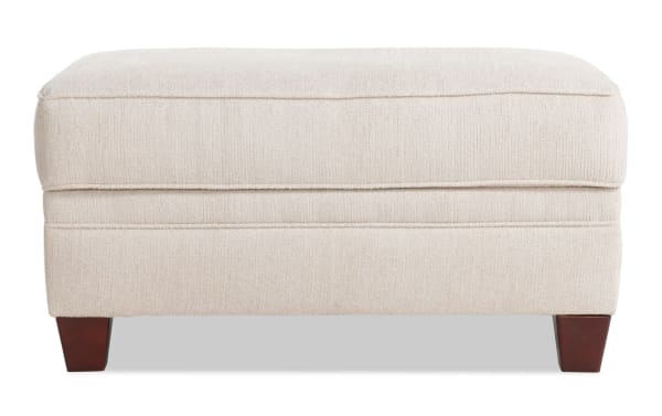 Portland Beige Storage Ottoman in transitional style with soft beige polyester fabric upholstery, tapered wooden legs, and cushioned top for seating and storage.