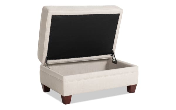 Beige Portland storage ottoman with soft polyester fabric upholstery, transitional style, hinged top for hidden storage, and wooden legs.