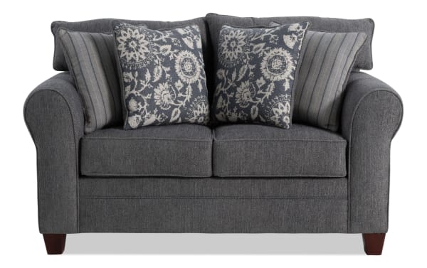 Portland Gray 65'' transitional loveseat in soft gray polyester fabric with rolled arms, two floral and two striped accent pillows, from Portland collection.