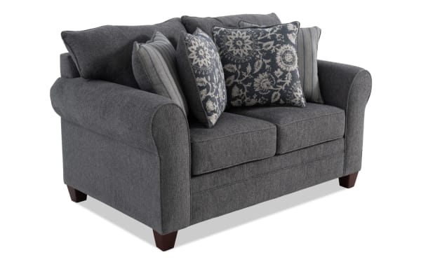 Portland Gray 65'' Loveseat in transitional style with soft gray polyester fabric, rolled arms, wooden legs, and decorative accent pillows.