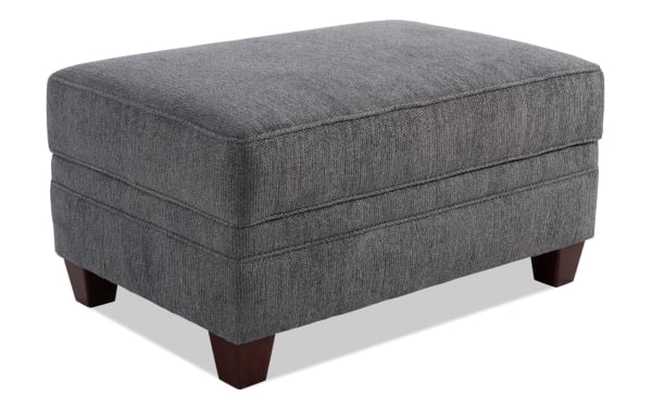Portland Gray Storage Ottoman in transitional style with soft gray polyester fabric upholstery, sturdy wooden legs, and cushioned top for seating or storage.