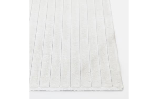Sofia 2' x 4' white solid washable rug with ultra-plush polyester fabric, medium pile, and transitional style for soft, cloud-like comfort.