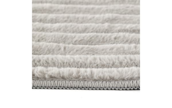 Light gray Sofia 5' x 7' transitional rug with ultra-plush medium pile polyester fabric, soft texture, and durable stitched edge trim.