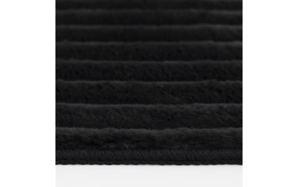 Transitional Sofia 2' x 4' black solid washable rug with ultra-plush medium pile polyester fabric, soft texture and striped pattern.