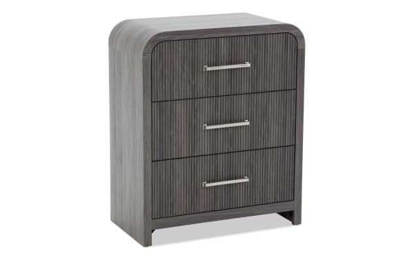 Dark gray wooden three-drawer chest with vertical grooves and silver metal handles, featuring rounded edges and a modern design.