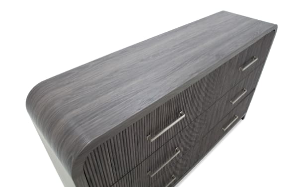 Modern gray wooden dresser with four drawers, horizontal metal handles, and rounded edges, ideal for bedroom storage.