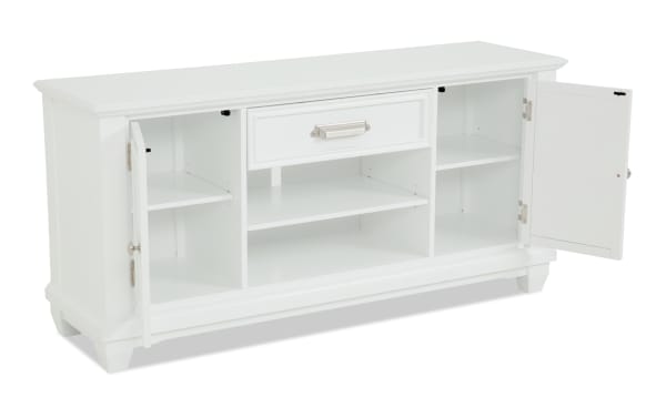 White wooden sideboard cabinet with two open doors, one central drawer, and multiple shelves for storage, featuring silver handles and a classic design.