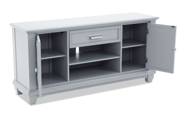 Gray wooden sideboard cabinet with two open doors, one central drawer with silver handle, and multiple shelves for storage.