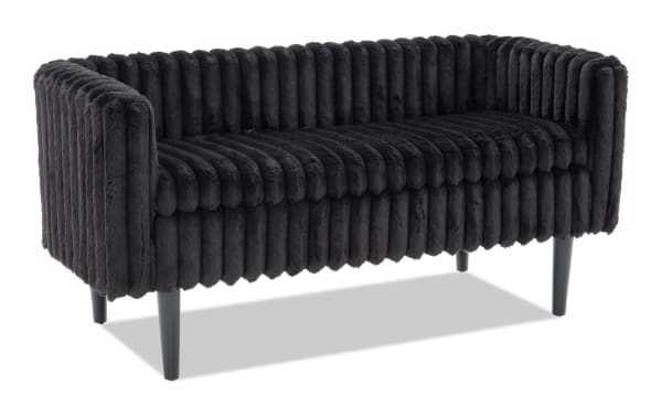 Modern black plush velvet loveseat sofa with vertical channel tufting and tapered black wooden legs, ideal for stylish living room seating.