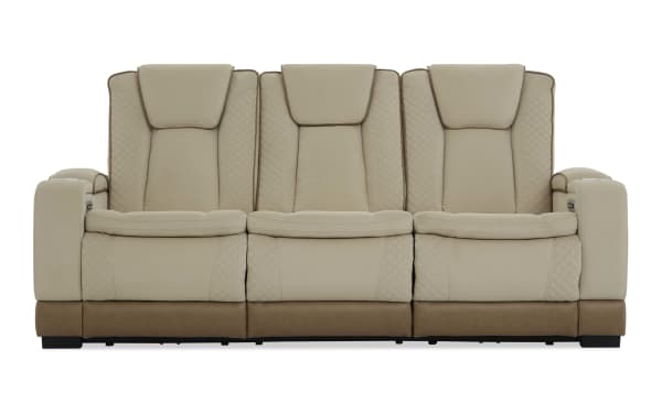 Beige and brown three-seater leather recliner sofa with quilted stitching, padded headrests, and armrest cup holders, modern living room furniture.