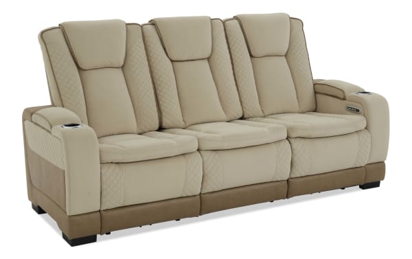 Beige and brown three-seater reclining sofa with quilted leather upholstery, padded armrests, cup holders, and built-in control panel for adjustable comfort.