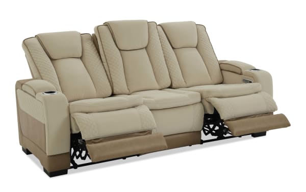 Beige and brown leather reclining sofa with quilted detailing, cup holders, and electric controls for home theater seating comfort.
