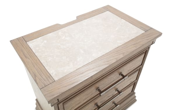 Wooden nightstand with a beige marble top, featuring three drawers with metal handles, showcasing a classic, elegant bedroom furniture design.