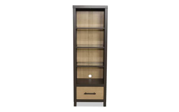 Tall wooden bookshelf with dark brown frame and light wood back panel, featuring three open shelves, one drawer with metal handle, and cable management hole.