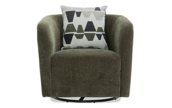 Olive green velvet swivel armchair with rounded arms and a geometric patterned throw pillow in shades of black, green, and beige.