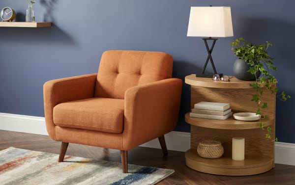 Contemporary Hampton Natural Half Oval End Table in beige MDF with two shelves, fabric upholstery, and decorative items for stylish storage.