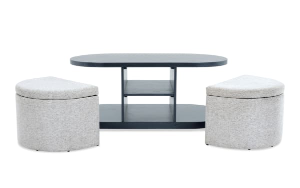 Contemporary Hampton Black & Gray Oval Storage Coffee Table with gray MDF shelves and two gray fabric polyester nesting footrests, featuring hidden storage and spacious shelving from the Hampton Entertainment & Occasional collection.
