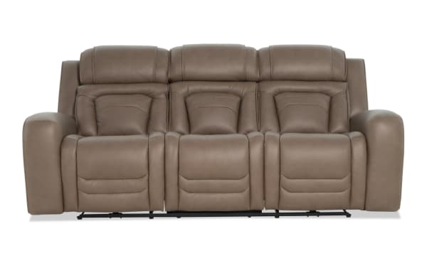 Taupe brown leather reclining sofa with plush cushioning, padded armrests, and segmented backrests designed for comfort and relaxation.