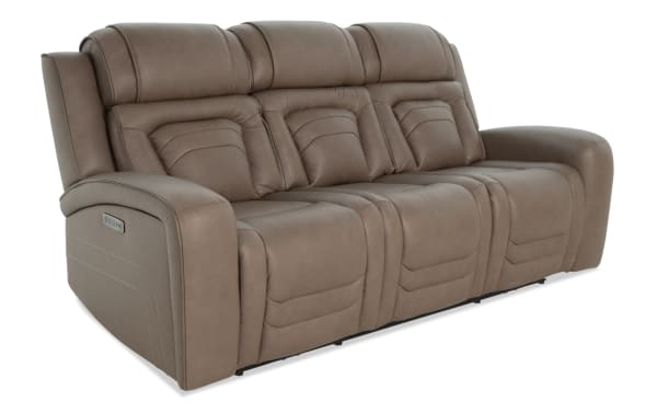 Taupe brown leather reclining sofa with plush padded cushions, segmented backrests, and wide armrests, designed for living room comfort.