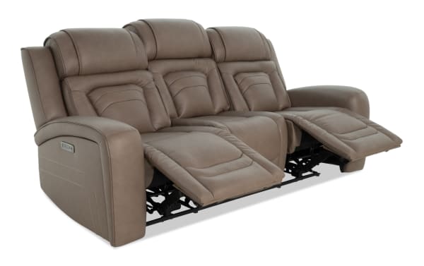 Three-seat brown leather reclining sofa with padded cushions, adjustable footrests, and stitched detailing, designed for living room comfort.