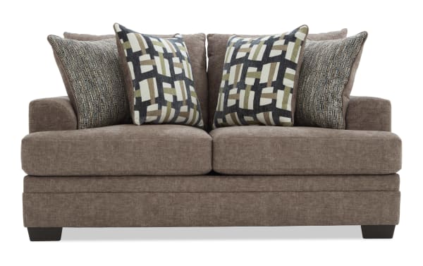 Brown fabric loveseat with four decorative cushions featuring geometric and textured patterns, designed for modern living room seating.