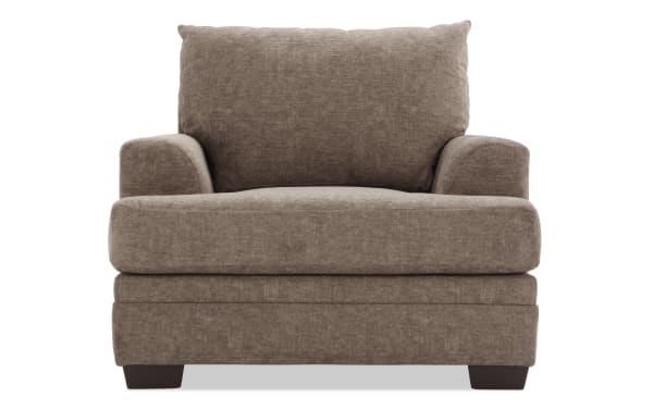 Brown upholstered fabric armchair with plush cushions, wide seat, and low wooden block legs, designed for living room comfort.