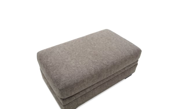 Rectangular brown fabric ottoman with cushioned top and soft textured upholstery, suitable for living room seating or footrest.