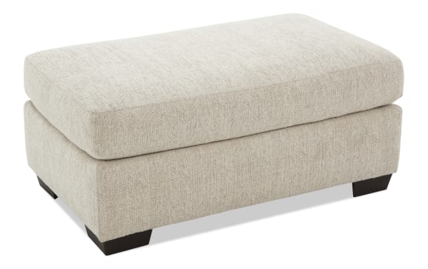 Beige Cypress Ottoman with plush Bob-O-Pedic® memory foam cushion, durable polyester fabric upholstery, and transitional style for living room comfort.