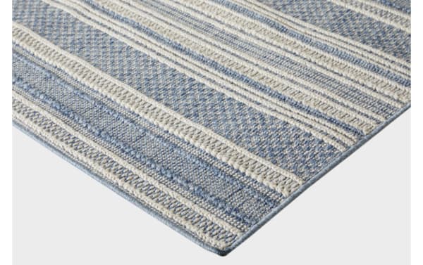 Woven blue and cream striped area rug with textured patterns and a flat weave, suitable for indoor living spaces.