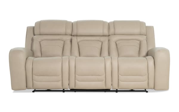 Beige leather three-seater reclining sofa with padded armrests and cushioned backrests, designed for living room comfort.