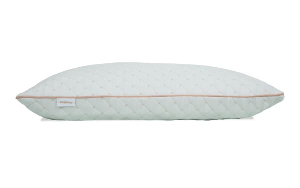 Quilted white rectangular pillow with beige piping and small diamond pattern, labeled "ESSENTIAL," designed for comfortable sleep support.