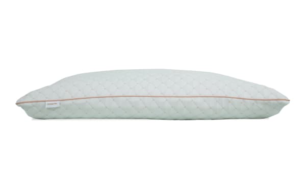 Quilted light blue rectangular pillow with beige piping and a small tag labeled "ESSENTIAL," designed for bedroom comfort and support.