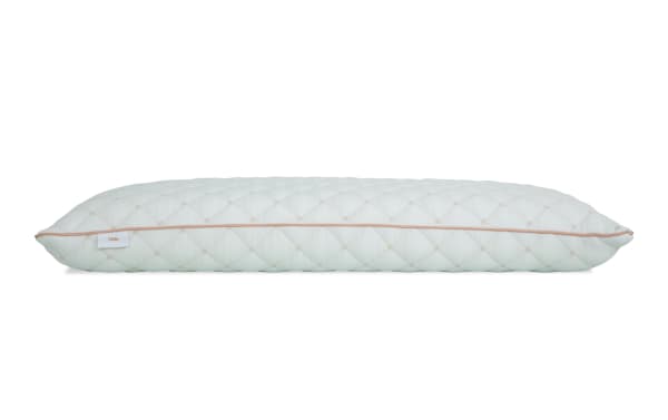 Firm pillow with quilted white fabric cover and beige piping, designed for supportive sleep comfort.
