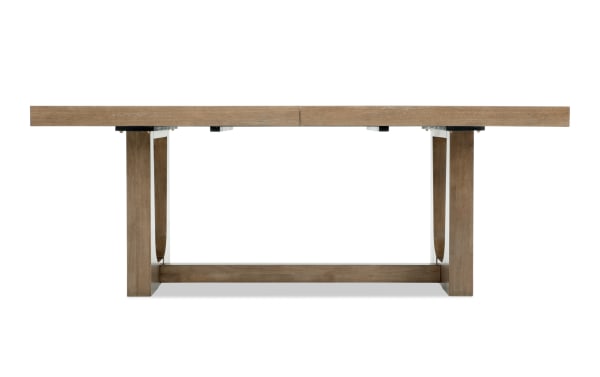 Rectangular wooden dining table with a natural brown finish, sturdy legs connected by a horizontal support beam, modern rustic style.