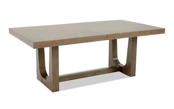 Rectangular wooden dining table with a natural brown finish, featuring a sturdy trestle base and a smooth, flat top surface.