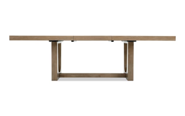 Rectangular wooden dining table with a natural light brown finish, sturdy square legs, and a modern farmhouse style.