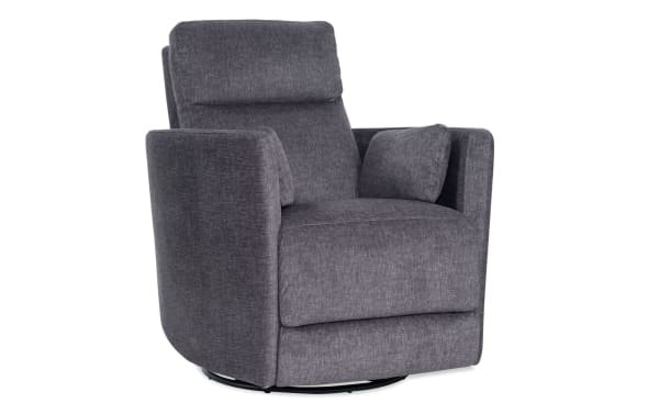 Dark gray fabric swivel recliner chair with cushioned armrests and lumbar support pillow, modern living room seating furniture.