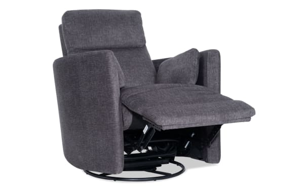Dark gray fabric upholstered recliner chair with cushioned armrests, padded backrest, and extended footrest on a circular swivel base.