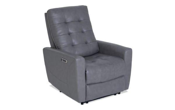 Gray leather recliner chair with tufted backrest and seat, featuring padded armrests and side control buttons for reclining adjustment.