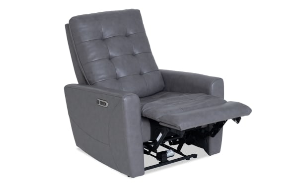 Gray leather power recliner chair with tufted backrest and cushioned seat, featuring side control buttons for adjustable comfort.
