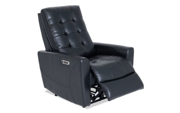 Black leather power recliner chair with tufted backrest, padded armrests, and extended footrest for enhanced comfort and relaxation.