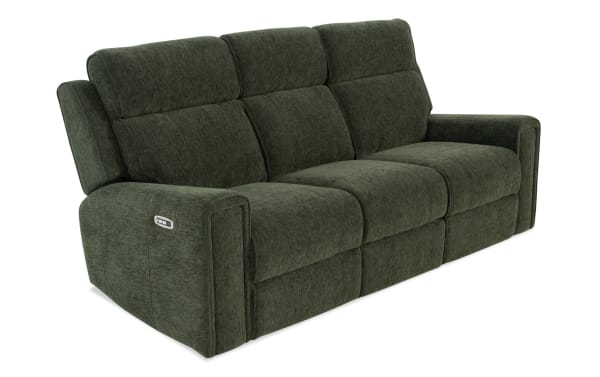 Dark green fabric reclining sofa with plush cushioning, wide armrests, and a built-in control panel on the left side for adjustable comfort.