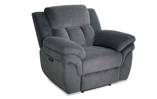 Dark gray plush fabric recliner chair with padded armrests and cushioned backrest, designed for comfort and relaxation.