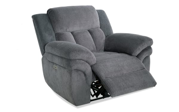 Gray fabric recliner chair with plush padded armrests and backrest, textured upholstery, and extended footrest for enhanced comfort.