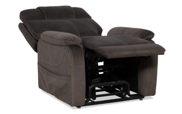 Dark gray microfiber recliner chair with padded armrests and backrest, featuring visible stitching and extended footrest for enhanced comfort.