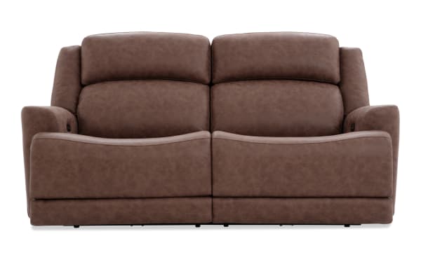 Brown leather reclining loveseat with plush cushioning, padded armrests, and a modern design suitable for living room seating.